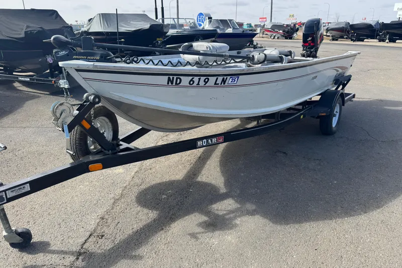 The Image of 2002 Alumacraft Yukon 165 boat on trailer in parking lot. - 1