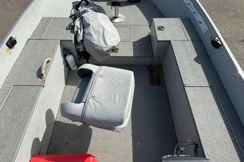 Slide: The Image of 2002 Alumacraft Yukon 165 boat interior with seating and storage compartments. - 10