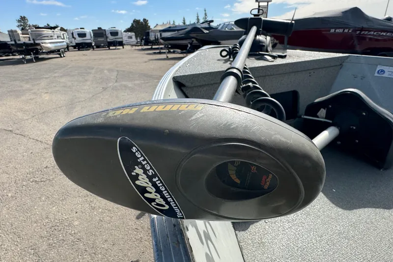 Slide: The Image of 2002 Alumacraft Yukon 165 boat with Cabela's trolling motor in a parking lot. - 6