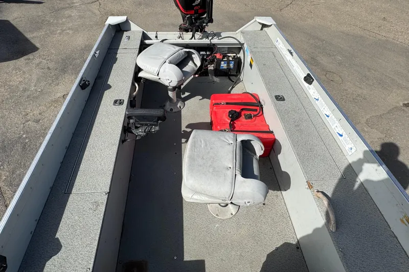 Slide: The Image of 2002 Alumacraft Yukon 165 boat interior with seats, motor, and storage compartments. - 7