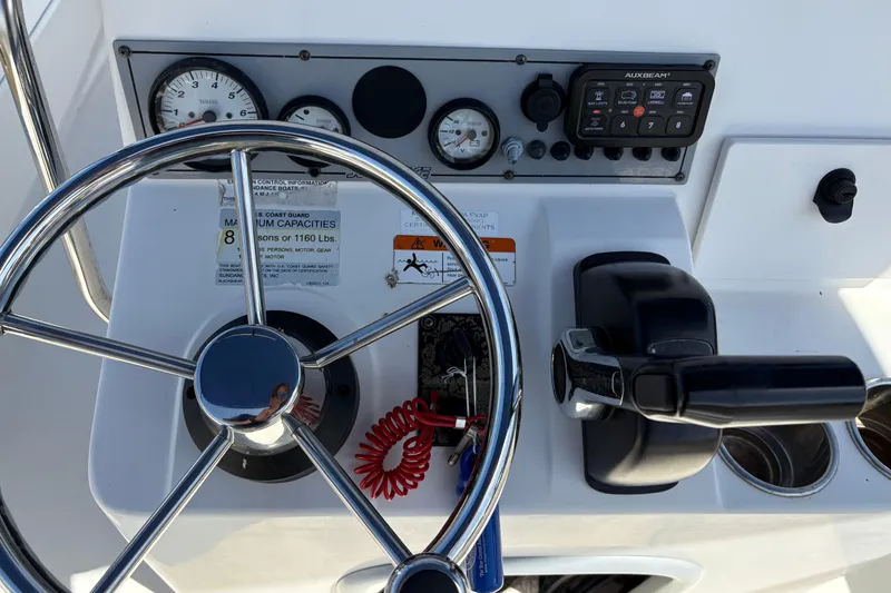 Slide: The Image of Steering console of 2014 Sundance B20CCR boat with gauges and controls. - 13