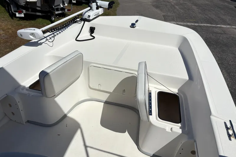 Slide: The Image of 2014 Sundance B20CCR boat interior with storage compartments and seating. - 18