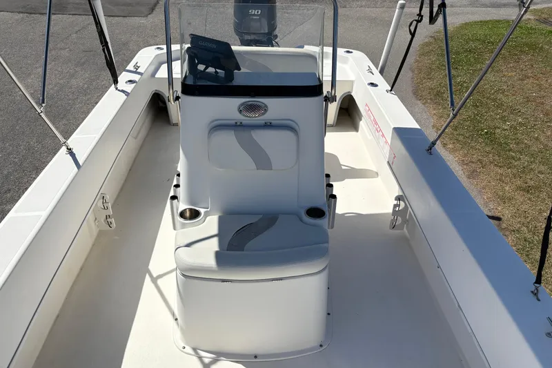Slide: The Image of 2014 Sundance B20CCR boat interior with seating and console, featuring Garmin equipment. - 19