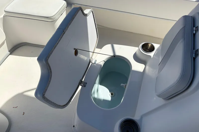 Slide: The Image of Open storage compartment on 2014 Sundance B20CCR boat with cup holders. - 20