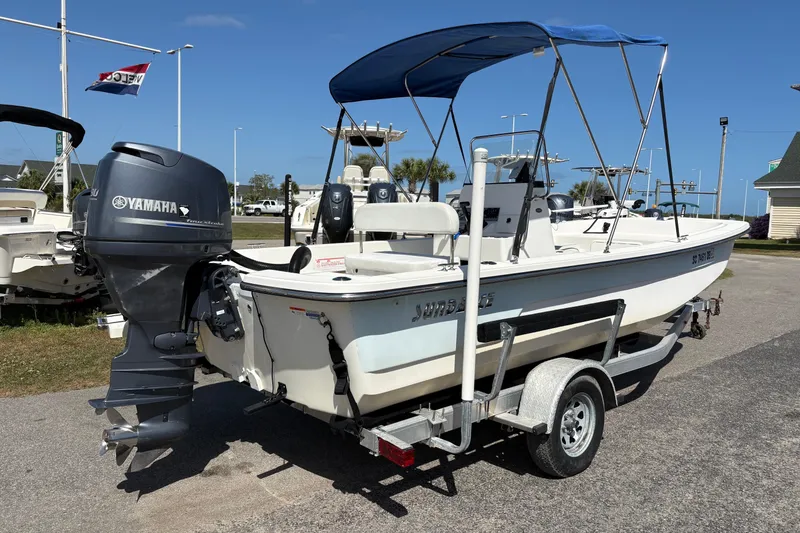 Slide: The Image of 2014 Sundance B20CCR boat with Yamaha outboard motor on trailer, parked outdoors. - 3