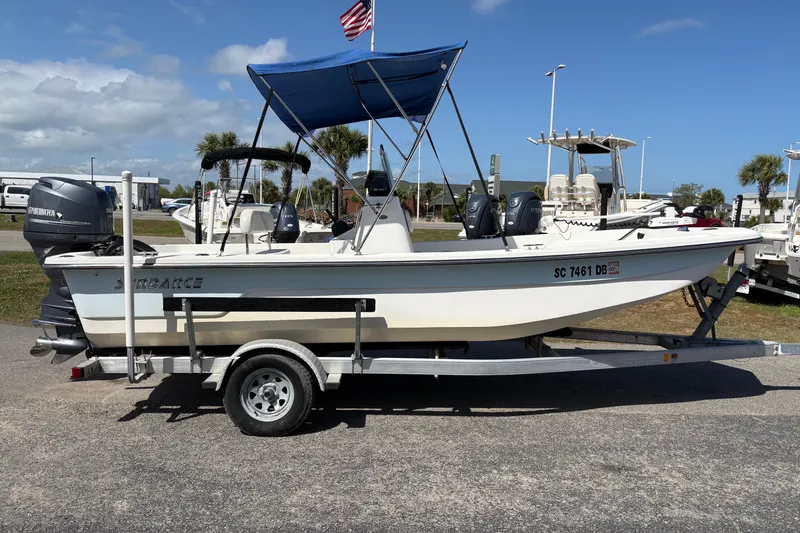 Slide: The Image of 2014 Sundance B20CCR boat on trailer with blue canopy and Yamaha outboard motor. - 4