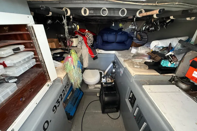 Slide: The Image of Interior of a 1988 Stuart Angler 32 boat with fishing gear and storage. - 12