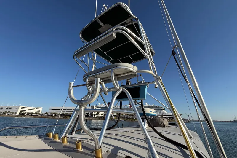 Slide: The Image of Stuart Angler 32 boat, 1988 model, featuring a tall observation tower against a clear blue sky. - 15