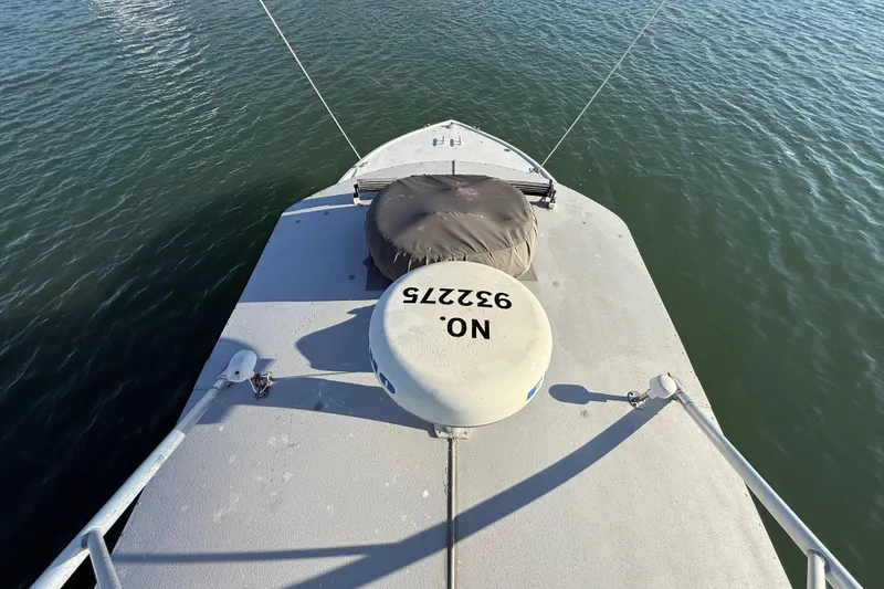 Slide: The Image of Bow view of 1988 Stuart Angler 32 boat on calm water. - 17