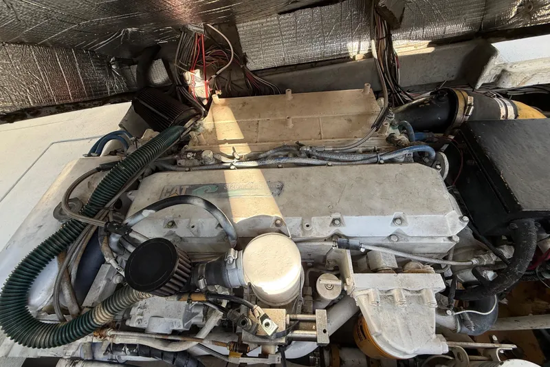 Slide: The Image of Engine compartment of a 1988 Stuart Angler 32 boat, showcasing mechanical components and wiring. - 20