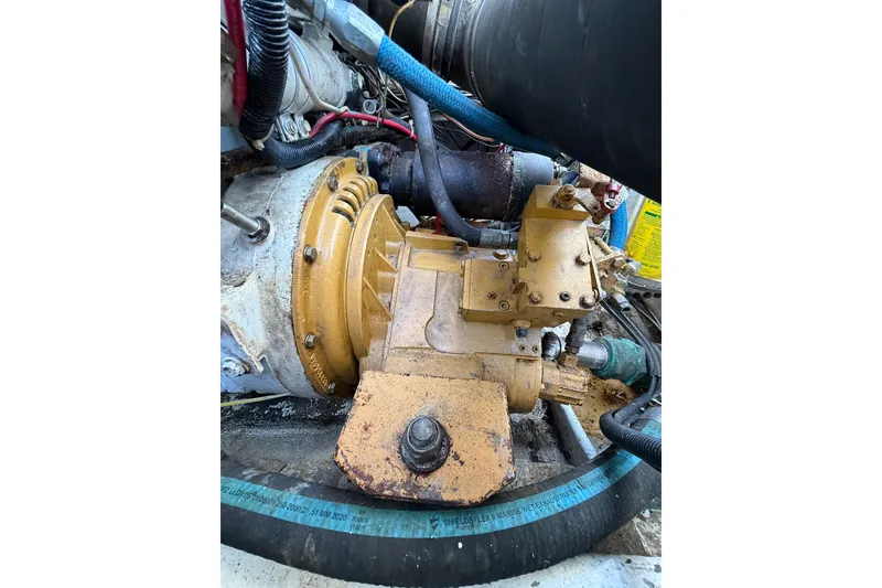 Slide: The Image of Engine compartment of a 1988 Stuart Angler 32 boat, showcasing mechanical components and hoses. - 21