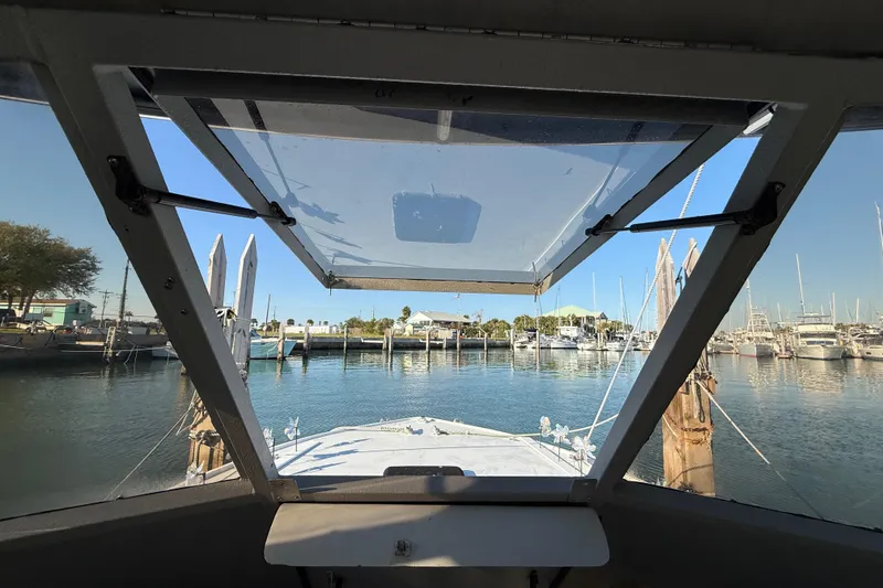 Slide: The Image of View from 1988 Stuart Angler 32 boat cockpit overlooking marina with clear blue sky. - 22