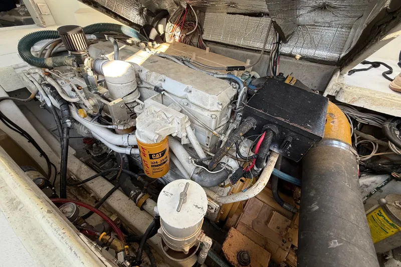 Slide: The Image of Engine compartment of a 1988 Stuart Angler 32 boat, showcasing mechanical components. - 23