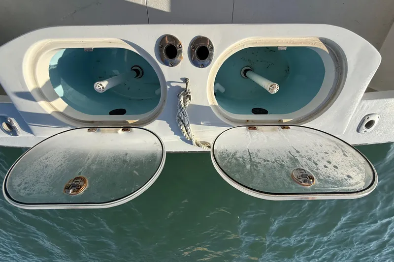 Slide: The Image of Open hatches on a 1988 Stuart Angler 32 boat, revealing storage compartments. - 24