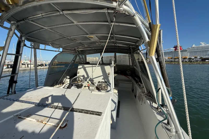 Slide: The Image of 1988 Stuart Angler 32 boat interior with steering wheel, docked at marina. - 8