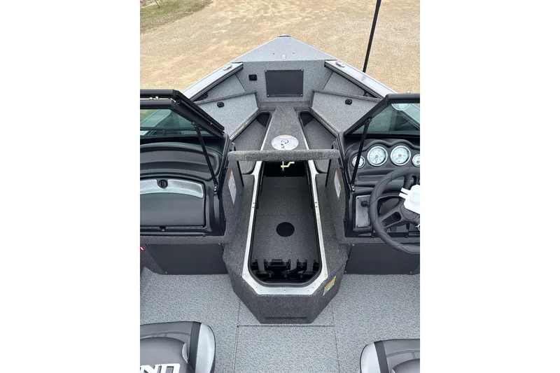 Slide: The Image of 2026 Lund 1875 Fisherman boat interior with steering console and storage compartments. - 3