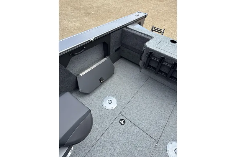 Slide: The Image of 2026 Lund 1875 Fisherman boat interior with gray carpet and storage compartments. - 7