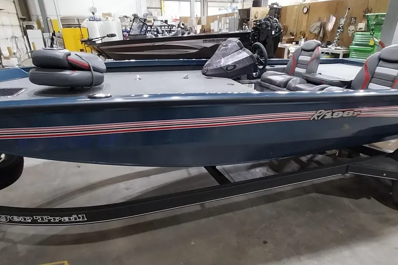 Slide: The Image of 2024 Ranger RT198P boat in a showroom, featuring sleek design and comfortable seating. - 10