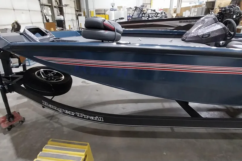 Slide: The Image of 2024 Ranger RT198P boat on trailer in a warehouse setting. - 11