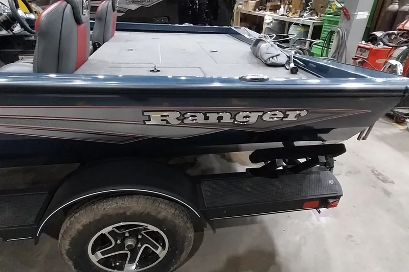 Slide: The Image of 2024 Ranger RT198P boat in a workshop, showcasing sleek design and branding. - 13