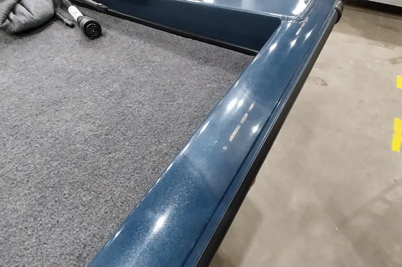 Slide: The Image of 2024 Ranger RT198P boat interior with blue trim and gray carpet flooring. - 15