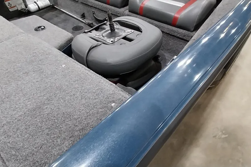 Slide: The Image of 2024 Ranger RT198P boat interior with gray and red seating, carpeted flooring, and storage compartments. - 16