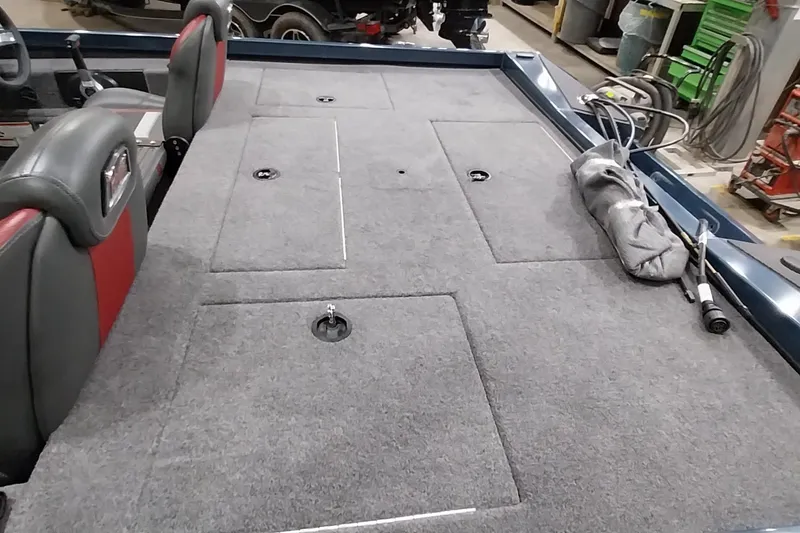 Slide: The Image of 2024 Ranger RT198P boat interior with gray carpet and storage compartments. - 17