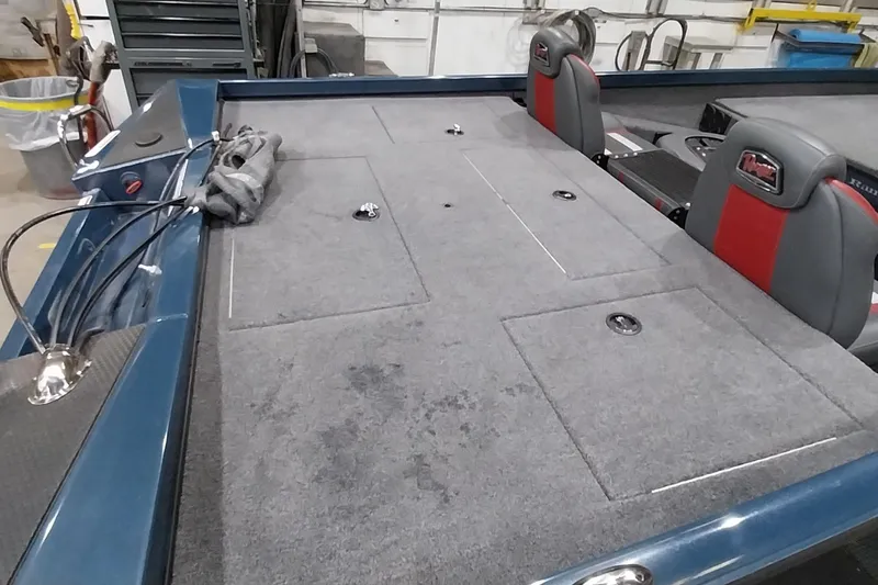 Slide: The Image of 2024 Ranger RT198P boat interior with gray carpet and dual seats. - 18