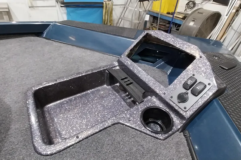 Slide: The Image of 2024 Ranger RT198P boat console with control panel and cup holder. - 23