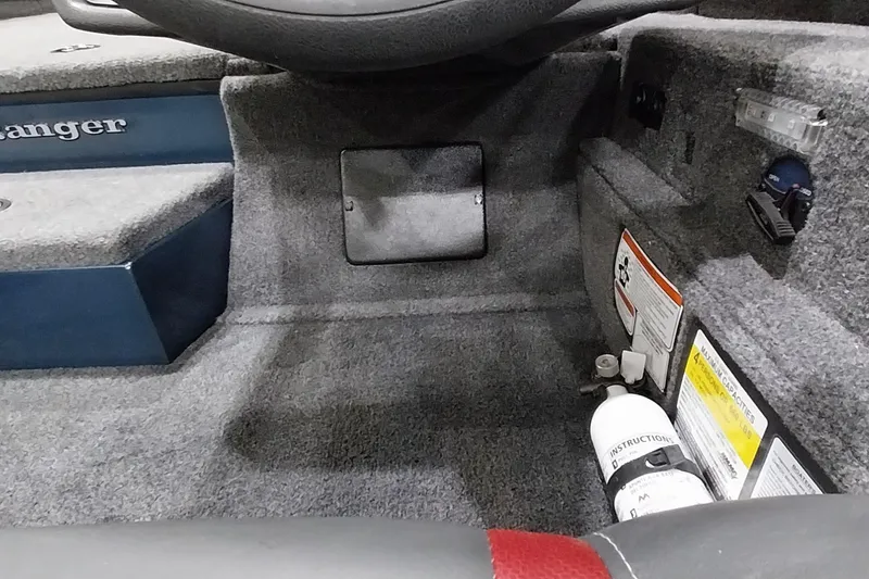 Slide: The Image of Interior view of 2024 Ranger RT198P boat, featuring carpeted flooring and safety equipment. - 27