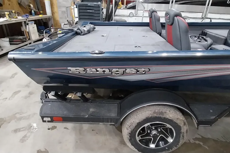 Slide: The Image of 2024 Ranger RT198P boat in a workshop, showcasing sleek design and comfortable seating. - 3