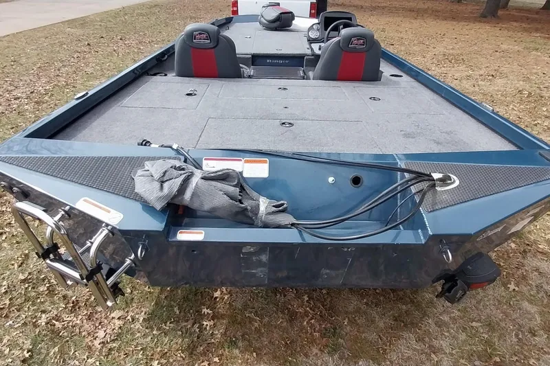 Slide: The Image of 2024 Ranger RT198P boat, rear view, on grass, showcasing spacious deck and seating. - 32