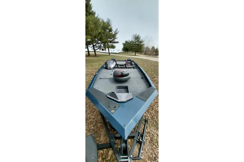 Slide: The Image of 2024 Ranger RT198P boat on trailer, parked near trees. - 35