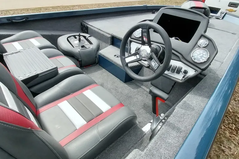 Slide: The Image of 2024 Ranger RT198P boat interior with steering wheel, gauges, and seating. - 39