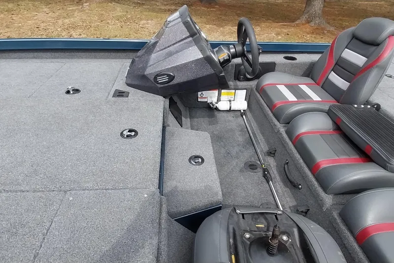 Slide: The Image of 2024 Ranger RT198P boat interior with steering console and cushioned seating. - 40