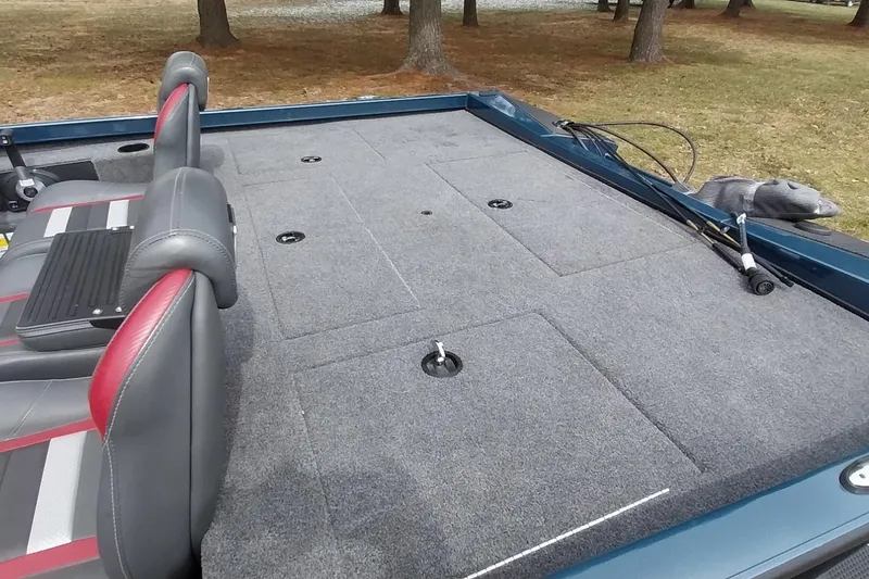 Slide: The Image of 2024 Ranger RT198P boat interior with gray carpeted deck and dual seats. - 42