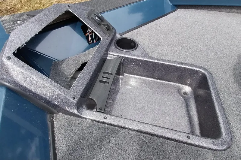 Slide: The Image of 2024 Ranger RT198P boat interior with storage compartment and cup holder. - 44