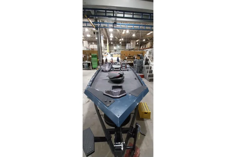 Slide: The Image of 2024 Ranger RT198P boat in a factory setting, showcasing its sleek design and construction. - 7