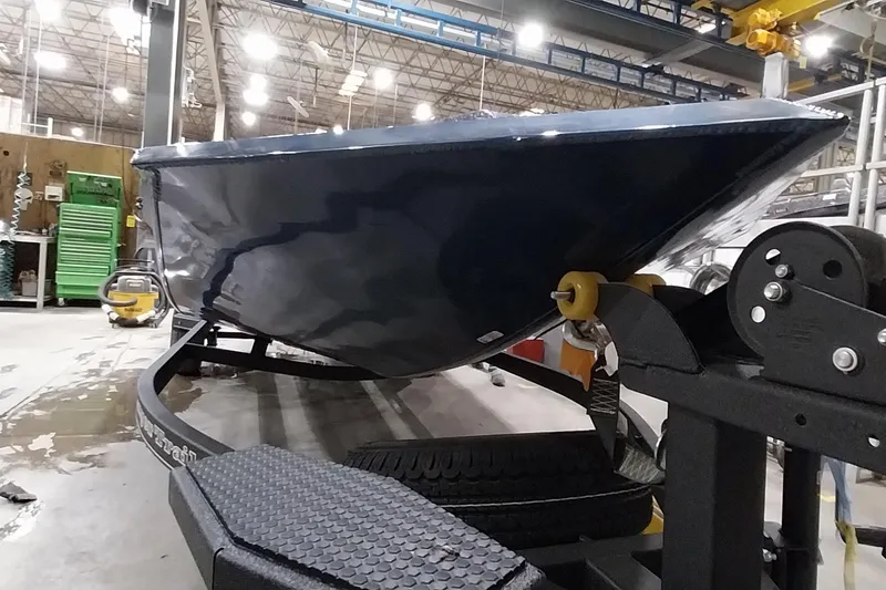 Slide: The Image of 2024 Ranger RT198P boat on trailer in industrial setting. - 8