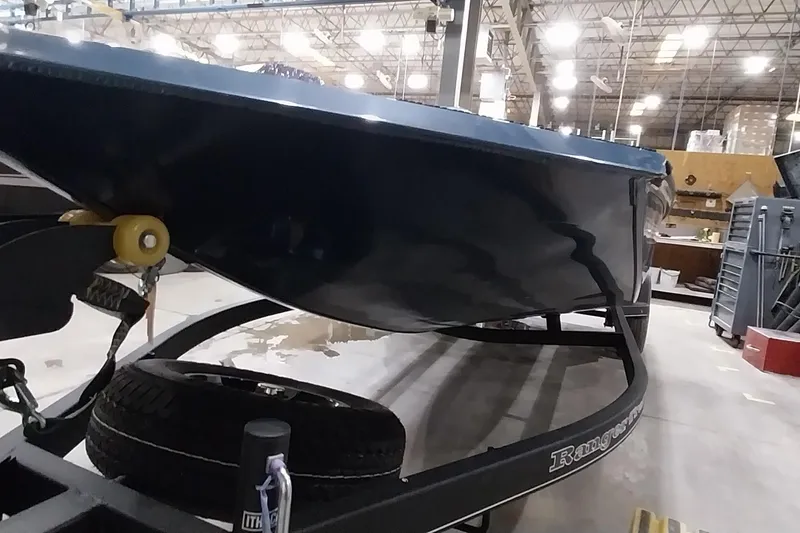 Slide: The Image of 2024 Ranger RT198P boat on trailer in warehouse setting. - 9