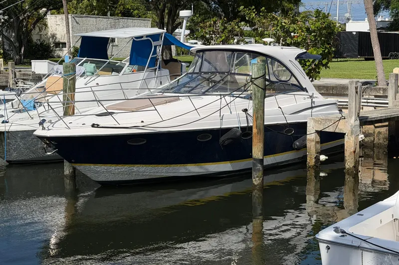 The Image of 2005 Regal Commodore 3860 yacht docked at marina, surrounded by other boats. - 0