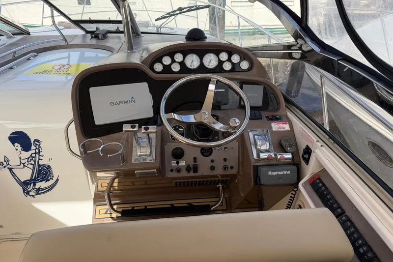 Slide: The Image of Cockpit of 2005 Regal Commodore 3860 with Garmin and Raymarine navigation systems. - 10