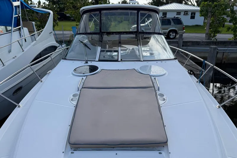 Slide: The Image of 2005 Regal Commodore 3860 yacht with sunpad, docked beside another boat. - 13