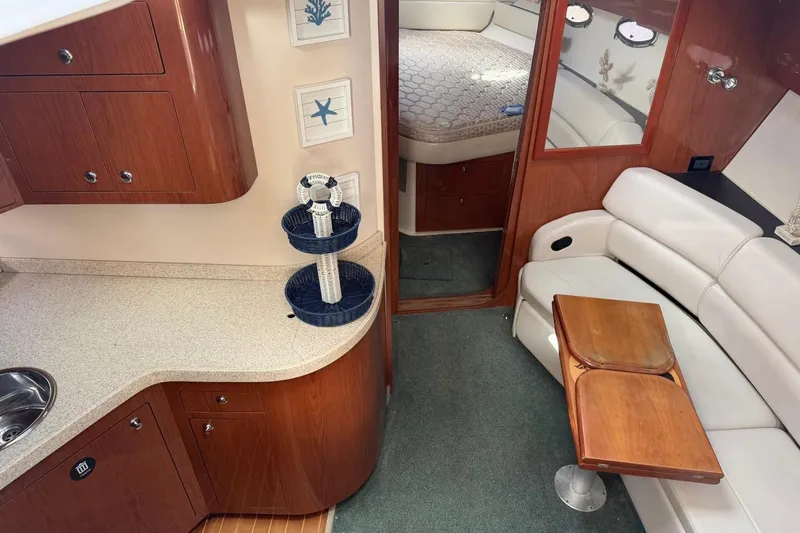 Slide: The Image of Interior of 2005 Regal Commodore 3860 yacht with wood cabinetry and seating area. - 14