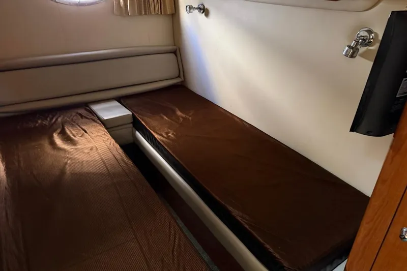 Slide: The Image of 2005 Regal Commodore 3860 cabin interior with twin beds and wall-mounted TV. - 16