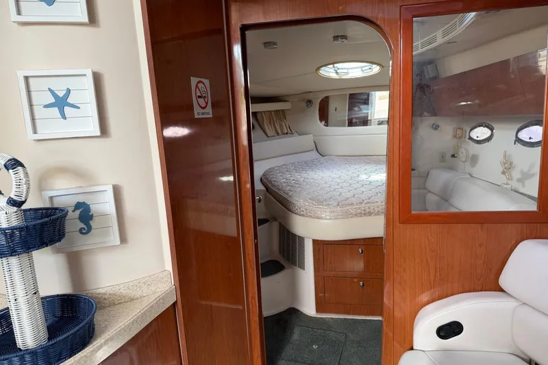 Slide: The Image of Interior of 2005 Regal Commodore 3860 yacht with cozy bedroom and nautical decor. - 19