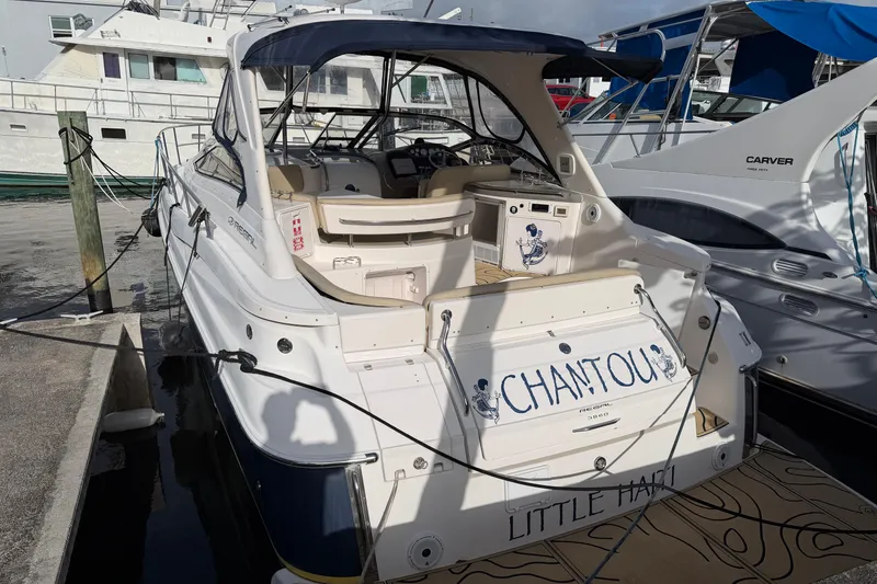 Slide: The Image of 2005 Regal Commodore 3860 yacht docked, featuring "CHANTOU" name on the stern. - 2