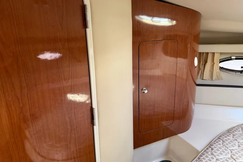 Slide: The Image of Interior of 2005 Regal Commodore 3860 yacht with wooden cabinetry and porthole window. - 20