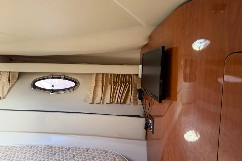 Slide: The Image of Interior of 2005 Regal Commodore 3860 yacht with TV and porthole window. - 21