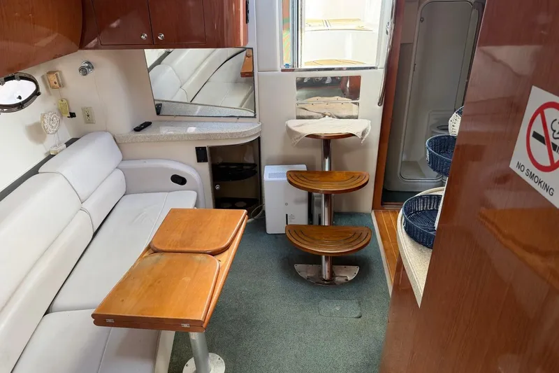 Slide: The Image of Interior of 2005 Regal Commodore 3860 yacht with seating, table, and no smoking sign. - 22